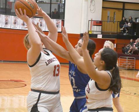 OFFENSIVE BOARD- Laci White had eight points in a 72-18 Levelland girls’ high school basketball home win over the Lake View Maidens last Friday. The Loboettes travel to Snyder Friday for a 6:15 p.m. game. Also pictured if Olivia Velardez. (Photo Courtesy of Jay Kelley)