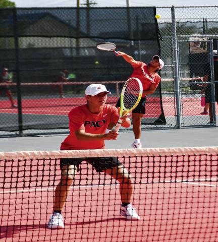 DOUBLE THE INTENSITY – Nathan Ellis gets in position for the set while William Canon serves it in a double’s matchup against Big Spring at the Levelland Tennis Courts on August 2. (Staff photo by Jentezen Smith)