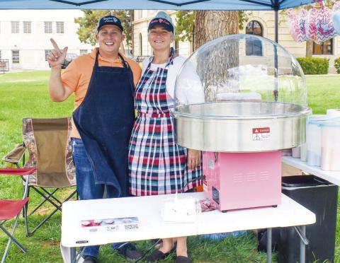 TWISTED SUGER- Gina and Joshua Randol participated in the Food Truck Thursday event in downtown Levelland Thursday at the Hockley County Courthouse lawn. Gina and Joshua are both teachers for the LISD and started a buiness selling cotton candy for parties and events. Pictured is Joshua and Gina Randol (Photo courtesy of Emily Campos)