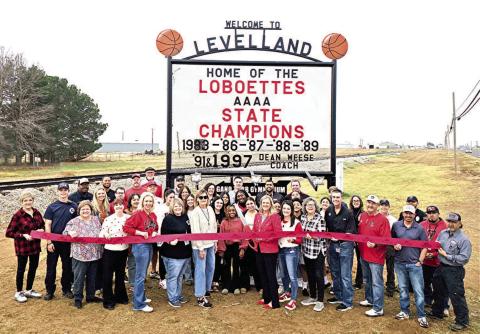NEW LOCATION-- The ribbon cutting for the restored and relocated Loboettes State Champions sign on Friday. The event drew city administration, city council members, Levelland Chamber of Commerce and KLB, LISD coaches and administration, former and current Loboettes basketball players, staff from Butch’s and Allied Oilfield among many others. (Staff photo by Lynda Work)