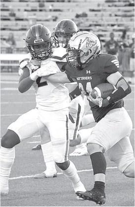 STRONG TACKLE- Levelland Lobo linebacker Ladarian Jordan fought off a stiff arm and pulled down a Lubbock High ball carrier during a road loss last Thursday. The Lobos will welcome the Estacado Matadors in to town for homecoming next Friday. (Photo Courtesy of Dom Puente)