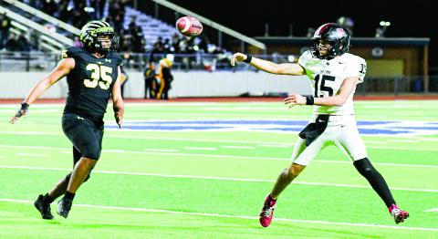 SCRAMBLE DRILL - Levelland quarterback Ethan Salazar scrambles to find an open receiver and makes a throw dur ing their playoff football game against Seminole in November at Frenship High School. (Staff photo by Jentezen Smith)