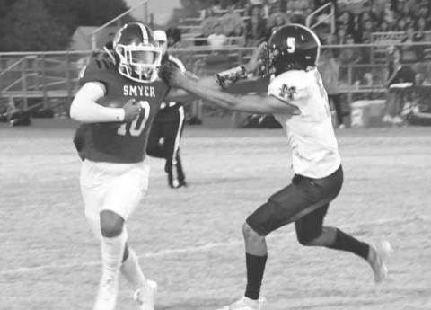 STIFF ARM - Smyer’s Peyton Casillas fended off Morton’s Alex Lopez in a 29-6 Smyer home loss last Friday. Smyer will be in Seagraves next while Morton will travel to New Home to face-off against an undefeated powerhouse. Both games will be on Friday at 7 p.m. (photo by Jay Kelley)
