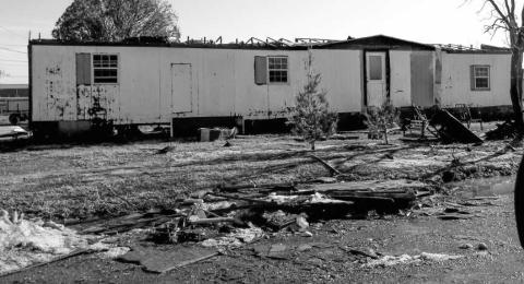 DESTRUCTION OF HOMES – Many residents are facing large repairs for their homes following the storm Wednesday. Roofs were destroyed along with windows blown out by large pieces of hail. Many homes also had their sidings littered with holes from the hail. Pictured is a mobile home that was ravaged by the winds and hail. (Staff photo by Karin Riddle)