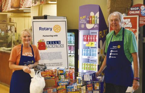 FOOD COLLECTION – Pictured is Phelps Blume and Amber Hinson of the Noon Rotary Club collecting donations for Bill’s Backpacks on Saturday. The club welcomes volunteers who help collect donations on the second Saturday of every month. The club collected $1,322.97 worth of items this past Saturday.They thank eveyone that donated (Staff photo)