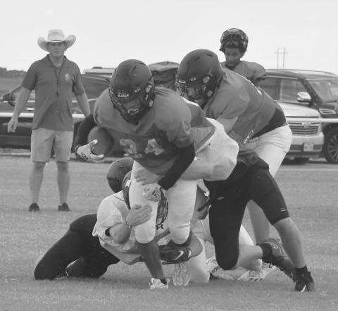 POWER- Whitharral Panther Nomar Gomez powered through a host of Lubbock Home School tacklers in the first scrimmage of the season last Friday in Whitharral. The Panthers will scrimmage in Petersburg next Friday at 5 p.m. (Photo Courtesy of Jay Kelley)