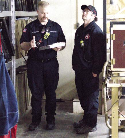 BUILDING SAFETY-- Pictured left to right conducting a fire inspection on a local business are Cade Millenbine, fire inspector and Lt. Jeff Pharis of the Levelland Fire Department. The inspections are being done to ensure all local businesses are up to code. (Staff photo by Eric Venkatesan)