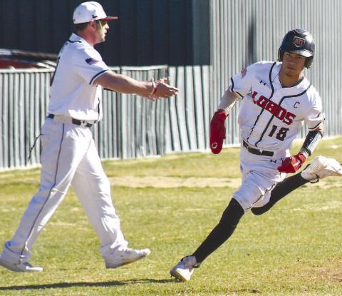 HEADED HOME- Lobo Joel Pena rounded third base on his way to scoring a run during the Levelland Line Drive Classic last weekend. Also pictured is Levelland Head Coach Chris Portwood. The Lobos had Tuesday off but will be back on the field Thurdsay for the Greenwood Tournament. (Staff Photo by Dom Puente)
