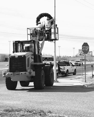 DECORATION REMOVAL- A crew from the City of Levelland Streets Department spent time Thursday morning removing the Christmas decorations that are placed on the light poles along the main city streets. (Staff photo by Dom Puente)