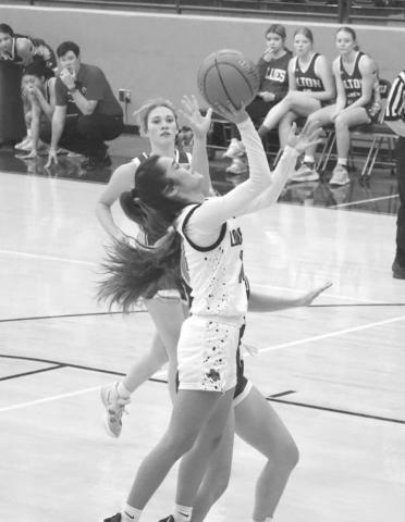 CONTESTED SHOT - Levelland Loboette Carly Tienda layed the ball up through the contact during the teams first game off the Littlefield Tournament against the Olton Phillies. (Staff photo by Aalijah Soliz)