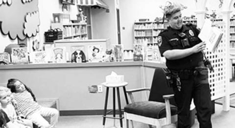 COMMUNITY READING - Librarian Abi Swain invited community members to come read to the students at Levelland Academic Beginnings Center. It was a learning experience on both sides as the students like to meet new people and the adults, get to see just how smart the students at LABC are. Pictured is Officer Josh Rincones reading 'Where the Wild Things Are' by Maurice Sendak, 1963. (submitted photo by Cristal Isaacks)