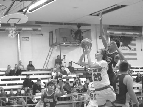 HEADS UP - Ropes Eagle Brennan Bearden layed the ball up with Whiteface Antelope Isaak Soliz giving chase in the Antelopes first game of the season at Ropes. (Staff photo by Aalijah Soliz)