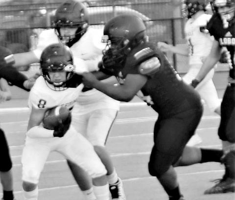 MAKING A PLAY- Levelland Lobo freshman Tanane Brackens pulled down a Seminole ball carrier last Thursday. The Levelland freshman team concluded their season with a loss at home to the Indians. (Staff Photo by Shawn Franklin)
