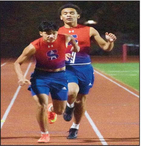 RELAY HANDOFF - Sundown’s Josh Hogan hands off to Roland Foster during a relay race. (Staff photo by Eric Venkatesan)