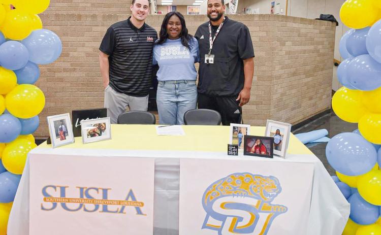 JOYCE SIGNS WITH SUSLA - Levelland Loboette Sydnii Joyce committed to Southern University Shreveport Louisiana to play collegiate basketball this past Wednesday in the Levelland High School commons area. Pictured with Joyce are Levelland’s Coach Bell (left) and Coach Flemmons (right). The SUSLA Lady Jags compete in NJCAA Division 1. (Photo provided by Levelland ISD)