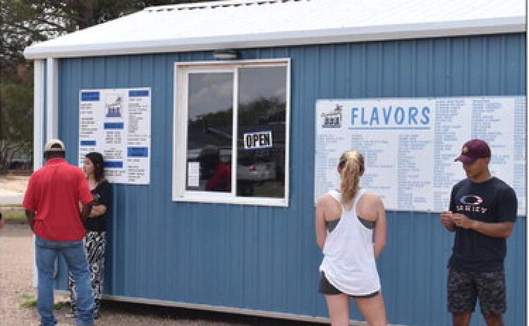 REFRESHING TREAT - Local citizens stopped in for a treat to cool off from the summer weather. (Staff photo by C.R. Calhoun)